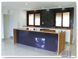 Modern-kitchen-with-tassie-oak-timber-benchtop-and-waterfall-ends